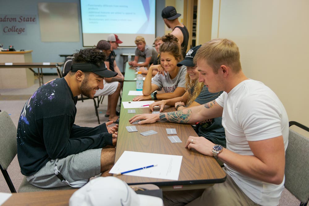 A group of business students discuss a project in the Burkhiser Technology Complex