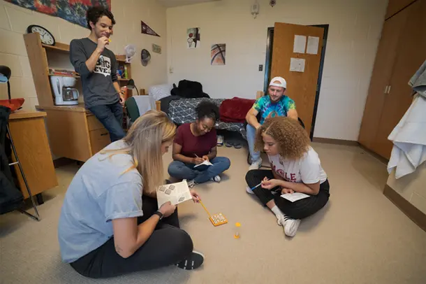 Students play a game in a residence hall